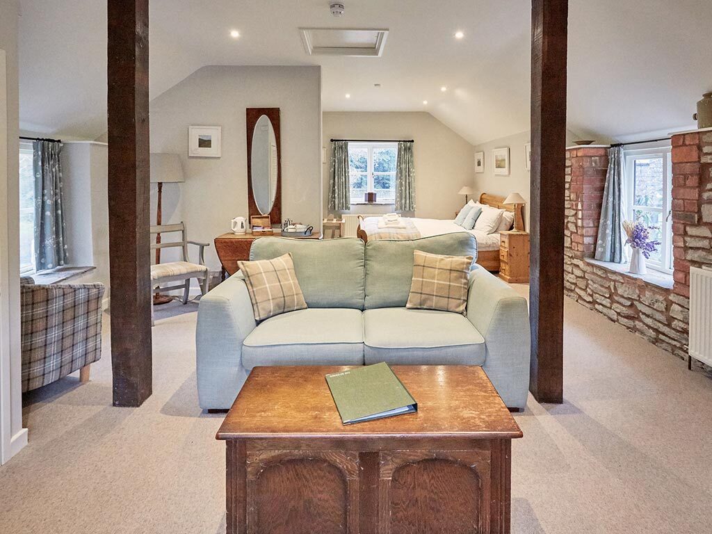 Hayloft Junior Suite - An open plan bedroom living space for hotel guests to relax and unwind in